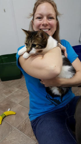 Amber with a big smile holding Honey, Honey is A dilute calico with white and has large dilated eyes